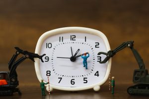 Miniature people : The team is working on an alarm clocks ,  working time concept